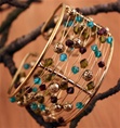 Wire and Bead Cuff, Each strand of wire is adorned with tasteful beads, in hues of light blue, olive green and earthy purple.  A fusion of East and West, modern and traditional, classic and trendy